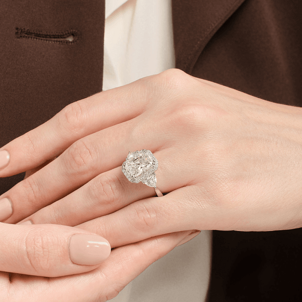 Hand wearing a diamond engagement ring, shown after jewellery cleaning.