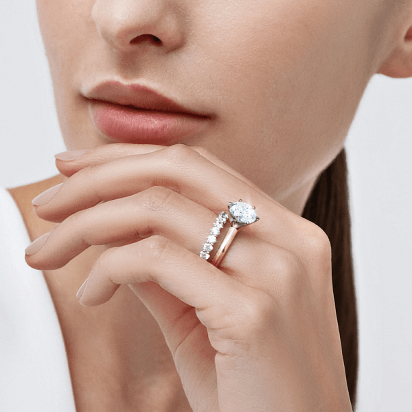 Image of a woman with neutral skin tone wearing jewelry made of different metals.